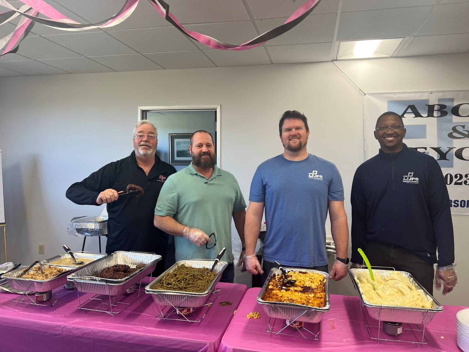JPS and Steel Partners leaders serving an employee cookout
